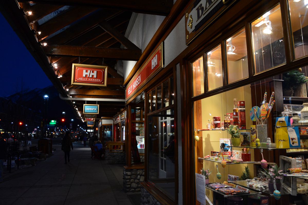 27B There Are Many Shops Along Banff Avenue With The Lights On After Sunset In Winter
